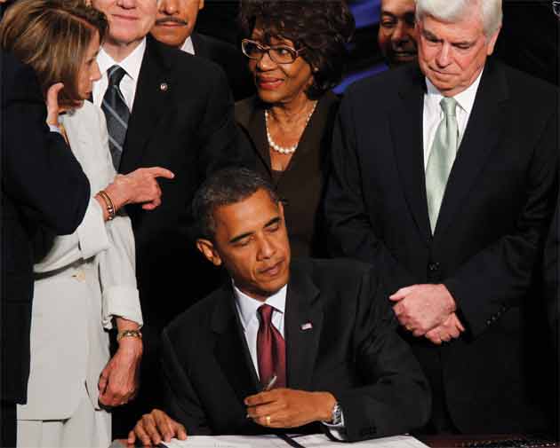 President Barack Obama signs the Dodd-Frank Act while then-House Speaker Nancy Pelosi, Rep. Maxine Waters and Sen. Chris Dodd look on.