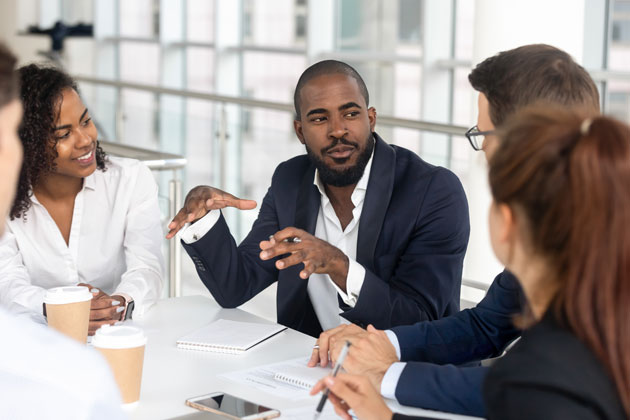 Black man leading a workplace discussion.