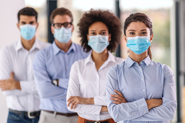 Employees with masks to protect against COVID