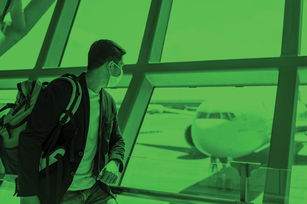 A green tinted image of a man wearing a backpack leaning against an airport window, looking out at a parked airplane.