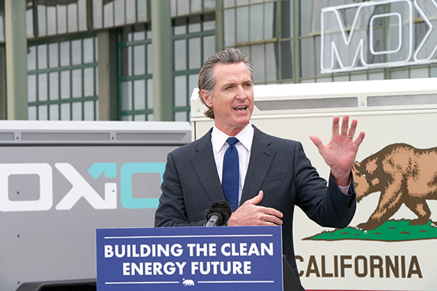 Governor Newsom talking at a podium that says 
