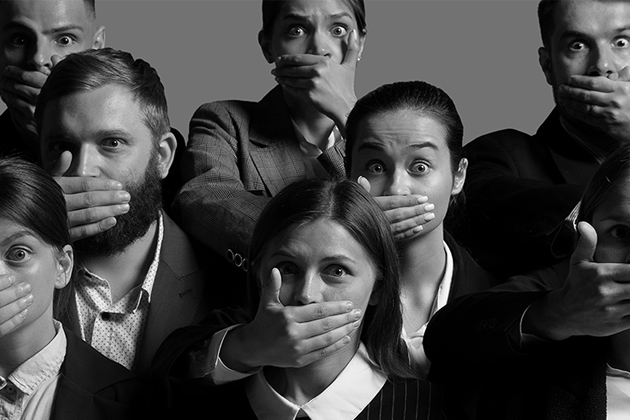 Black and white photo of people covering their mouths with their hands