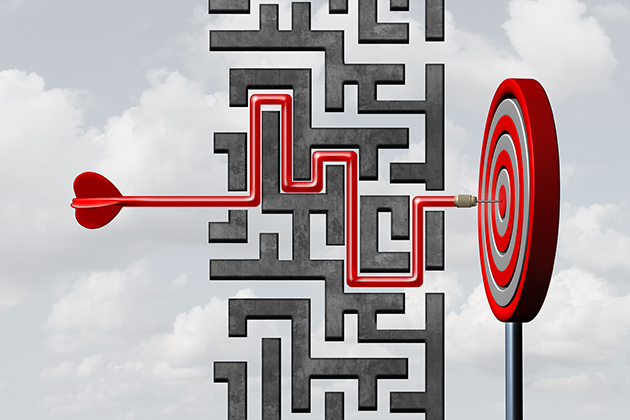 Red dart winding its way through a maze toward a bullseye on a dartboard